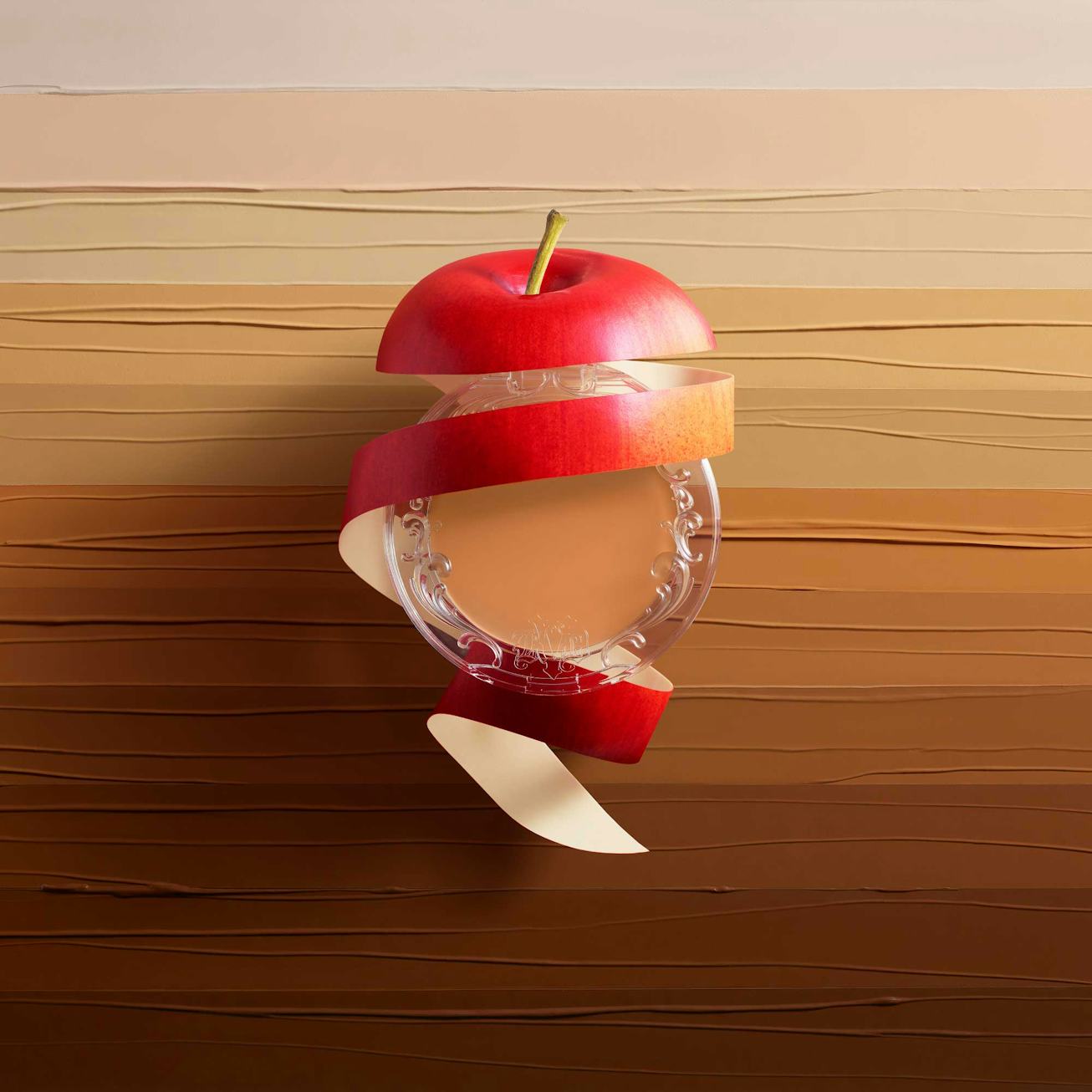 An unpeeled apple surrounds a palette of KVD Beauty Good Apple Skin Perfecting Foundation Balm