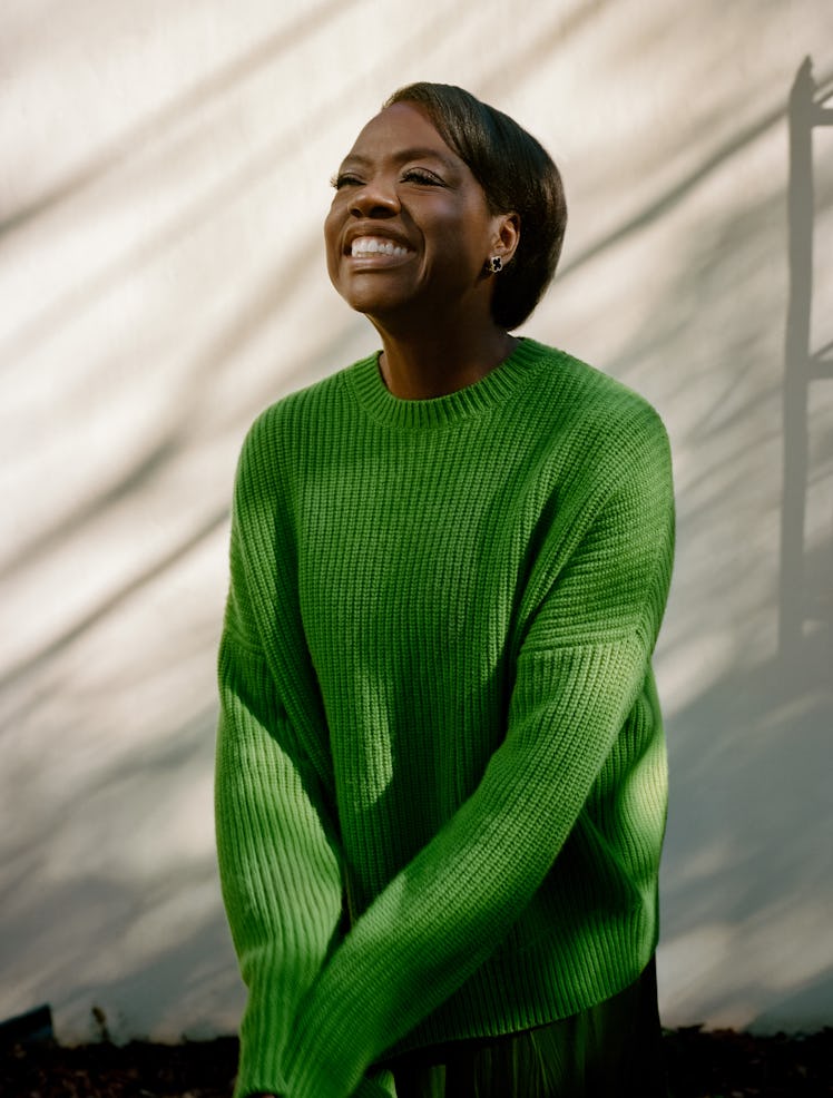 Viola Davis smiling in a vibrant green sweater