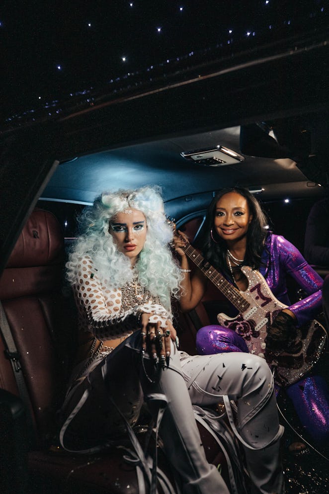 A behind-the-scenes photo of guitarist Malina Moye and Bella Thorne filming the "Phantom" music vide...