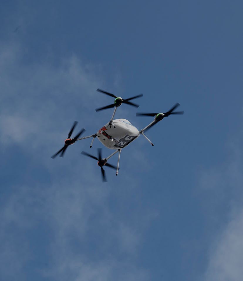 A Manna drone carrying a Samsung product is seen hovering in the air.