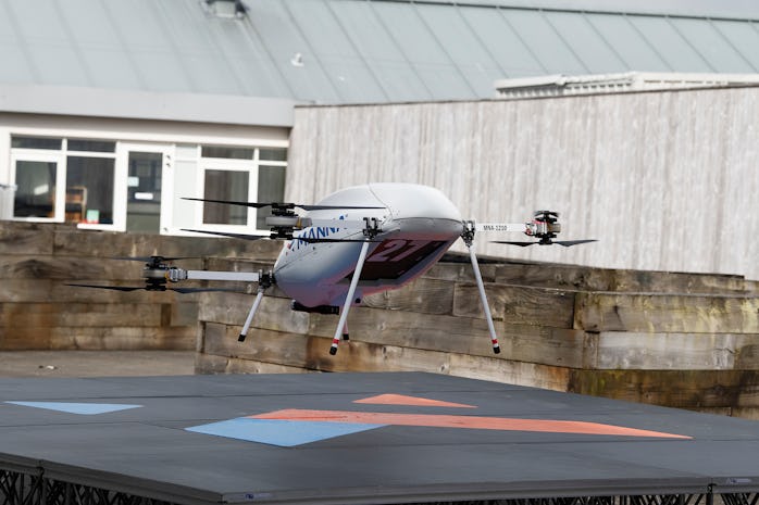 A large sized Manna drone is seen taking off of the ground. This drone is being used to deliver Sams...