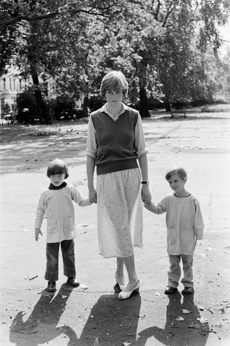 Lady Diana Spencer (Princess Diana) holding hands with students