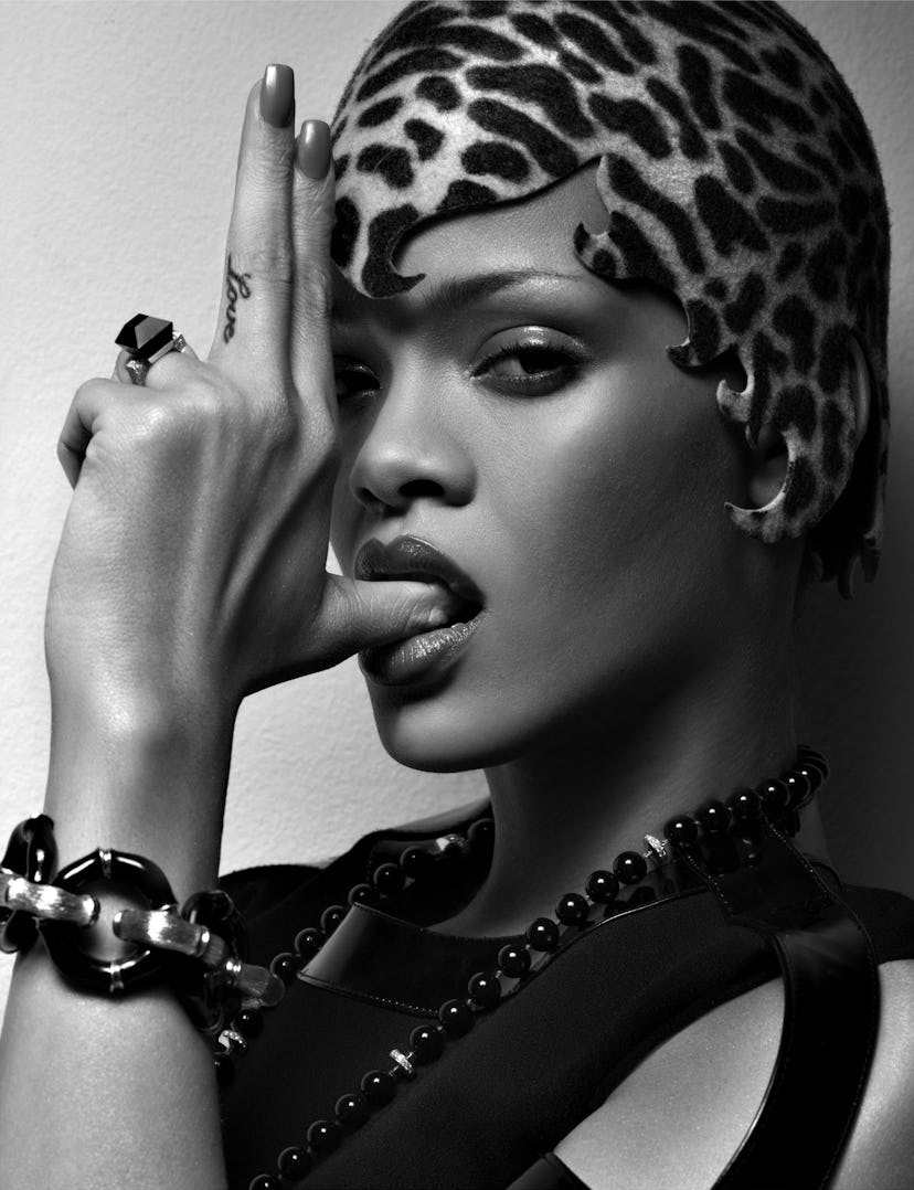Rihanna doing the pistol pose with her fingers pointed upwards