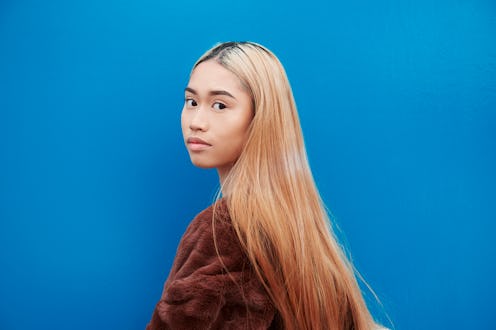 Coconut milk for hair is a secret hero for dry scalp and brittle strand woes — here's how to use it.