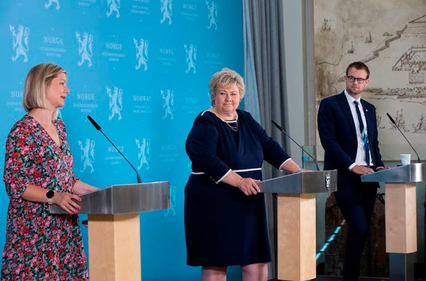 Norwegian Prime Minister Erna Solberg, center, with other government ministers, holds a pandemic pre...