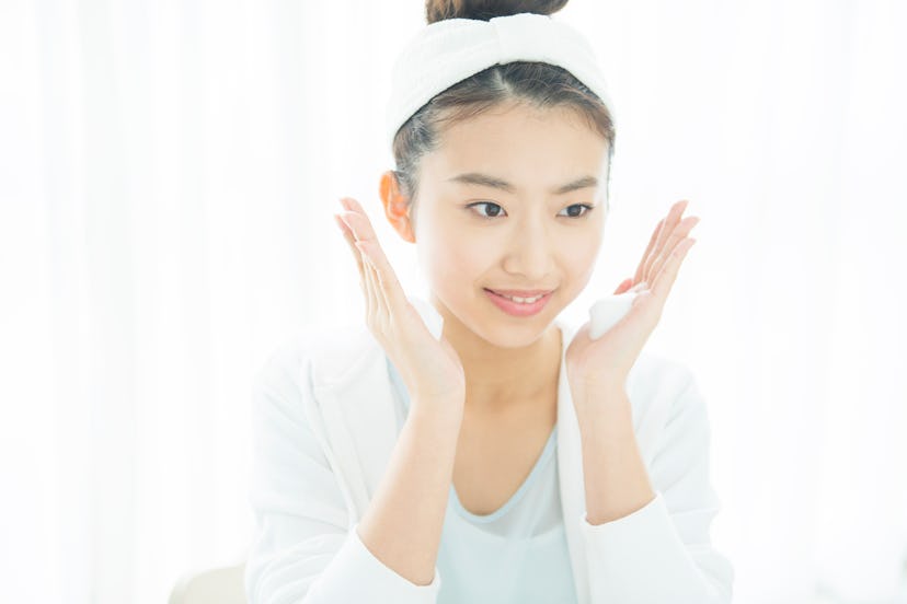 woman washing her face