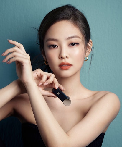Blackpink's Jennie Kim' in a black off-the-shoulder top holding Hera's lip product
