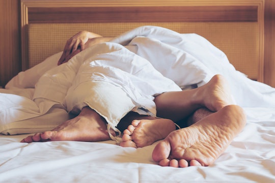 Couple's feet in bed