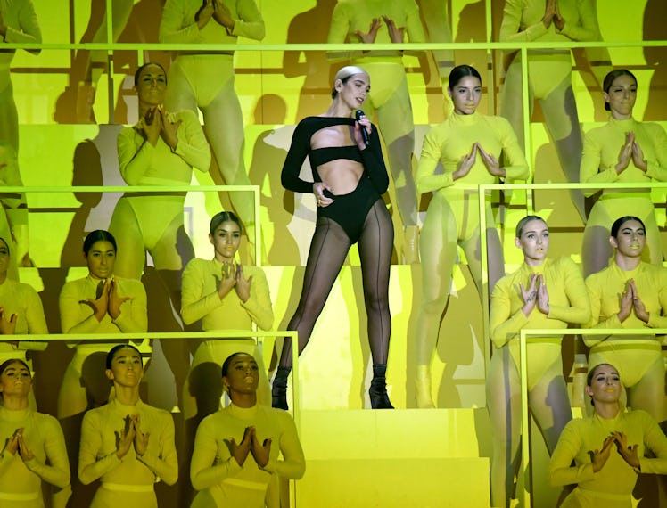 Dua Lipa on stage singing wearing a Mugler Bodysuit