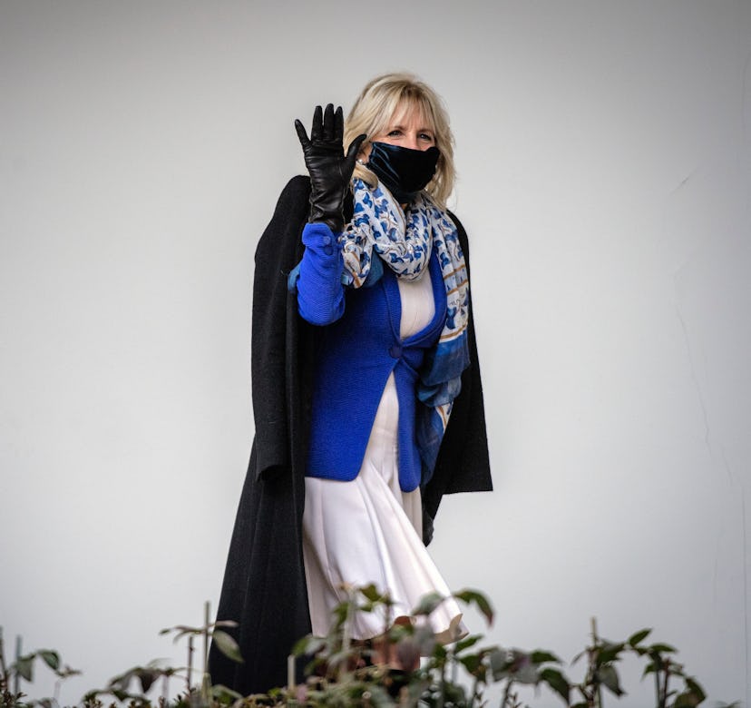 First Lady Dr. Jill Biden waves to cameras as she walks along the colonnade at the White House after...