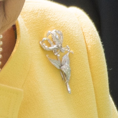 Get to know the stories behind Queen Elizabeth's most memorable brooches, from her palm leaf brooch ...