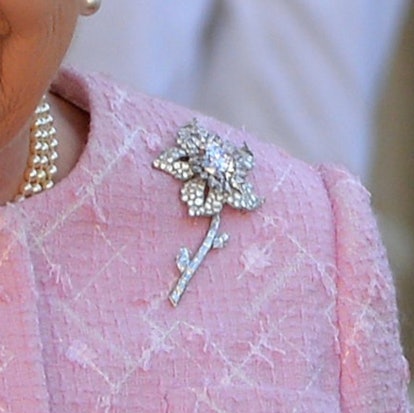 Get to know the stories behind Queen Elizabeth's most memorable brooches, from her palm leaf brooch to her true lover's knot brooch. 