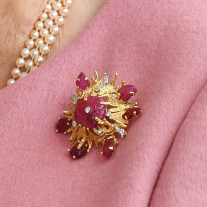 Get to know the stories behind Queen Elizabeth's most memorable brooches, from her palm leaf brooch ...