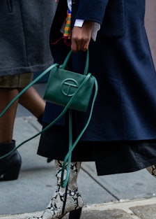 A person carrying a green Telfar bag 
