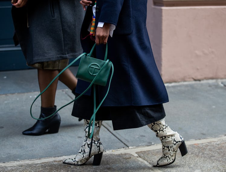 A person carrying a green Telfar bag