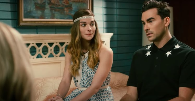 Alexis and David Rose sit on a bed at the Rosebud Motel in 'Schitt's Creek.'