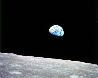 An image of the Earth over the surface of the Moon