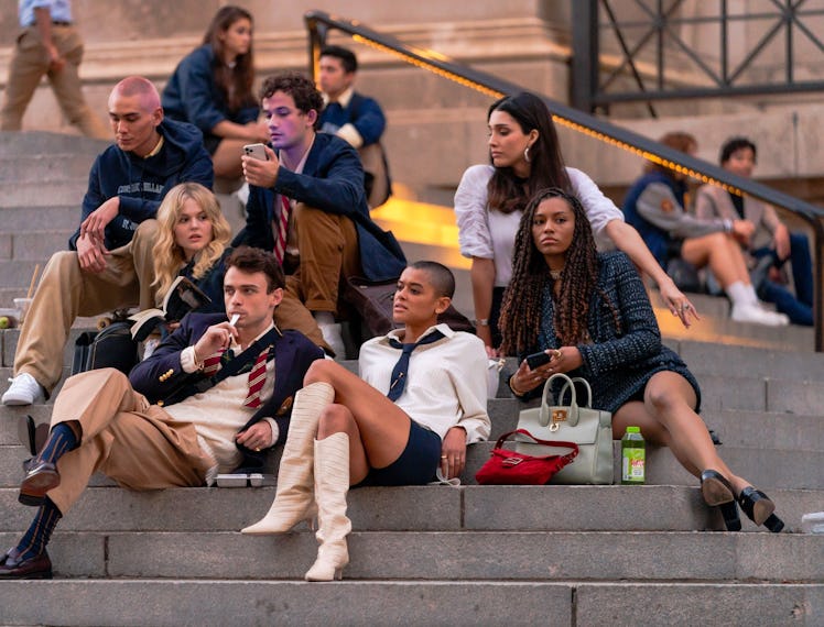 A screenshot from the Gossip Girl reboot with the cast sitting on the Met steps