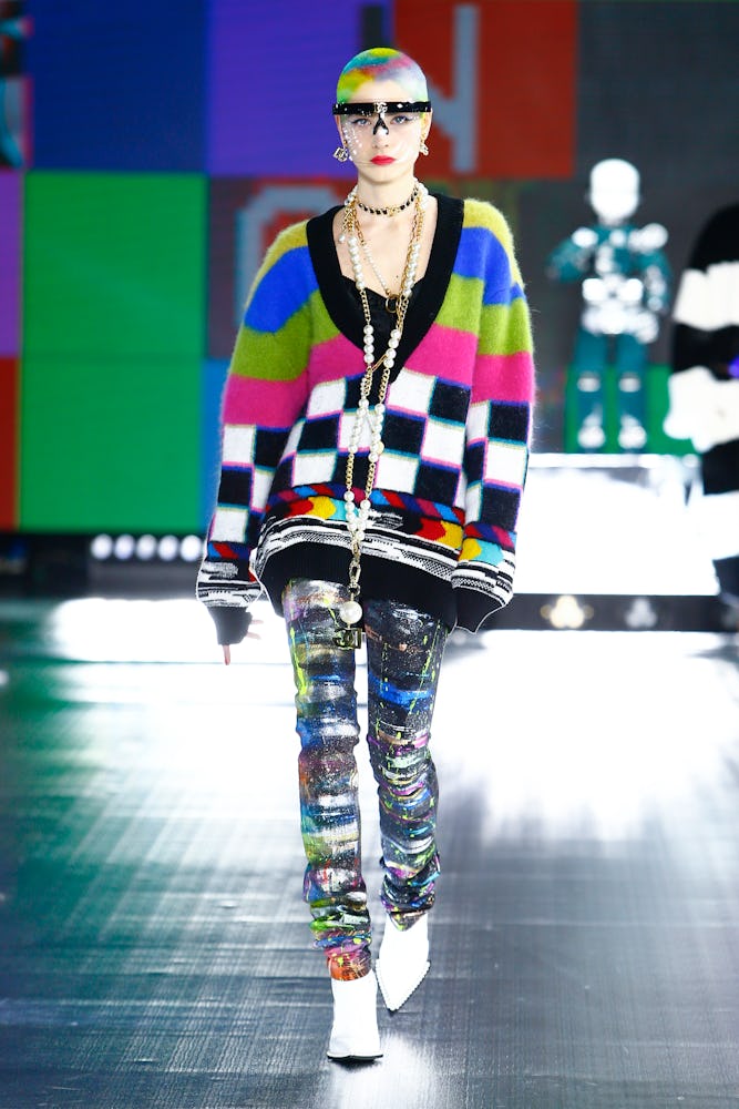 A model in a multi-color knit sweater and multi-colored pants at Dolce & Gabbana's Fall 2021 Runway
