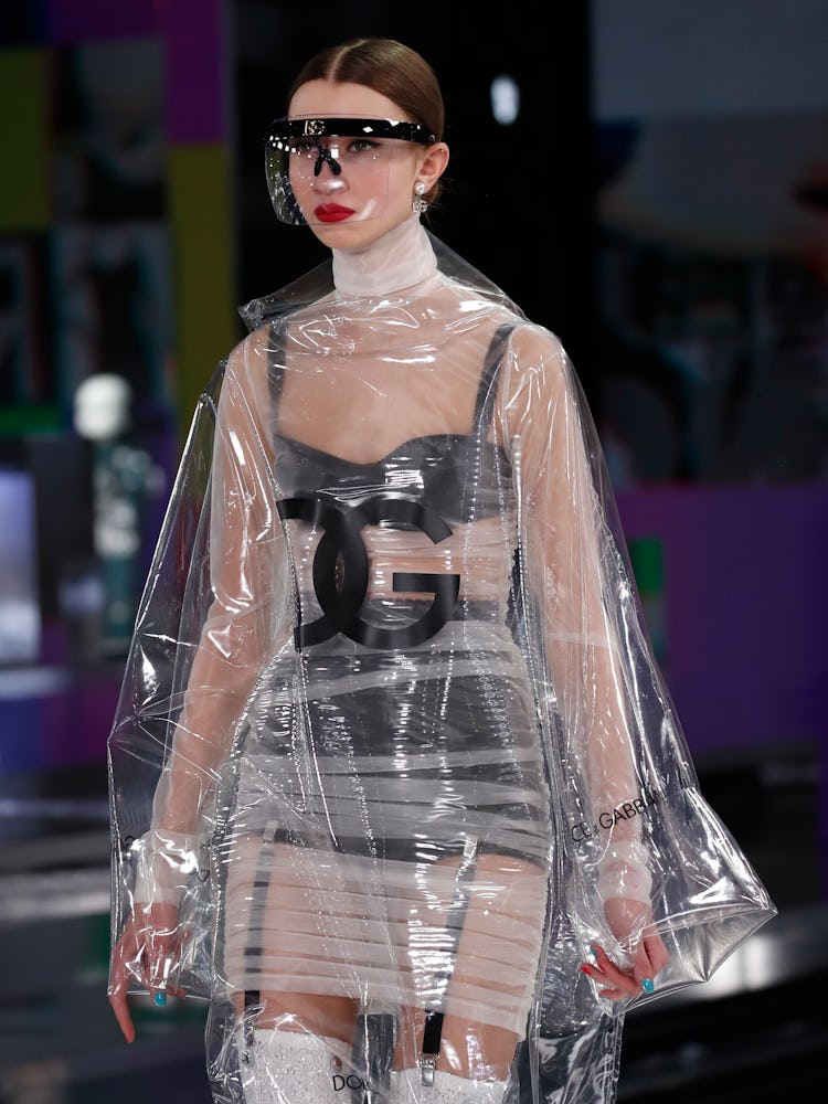 A model in black underwear and a see-through raincoat at Dolce & Gabbana's Fall 2021 Runway
