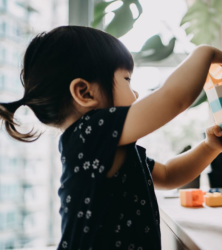 toddler playing with building blocks
