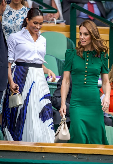 Meghan Markle in a white shirt and blue-white skirt and Kate Middleton in a green dress