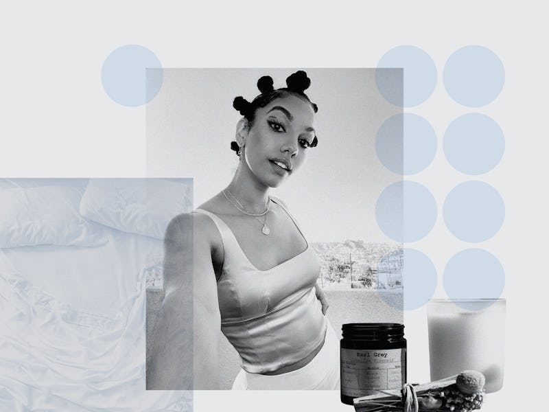 Corinne Foxx in a tank top shirt, posing in her bedroom with her beauty products in front of her