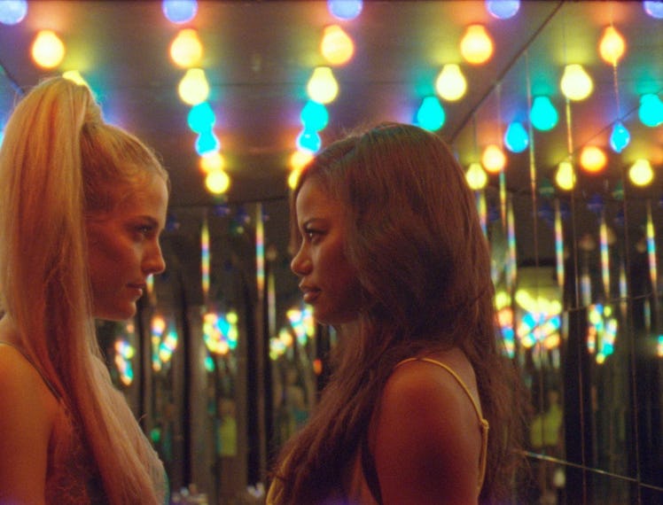 Riley keough and Taylour Paige staring at each other