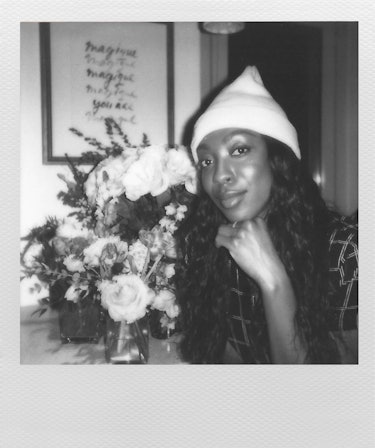 Actress Ego Nwodim, a cast member of SNL, wearing a bright beanie with flowers next to her.