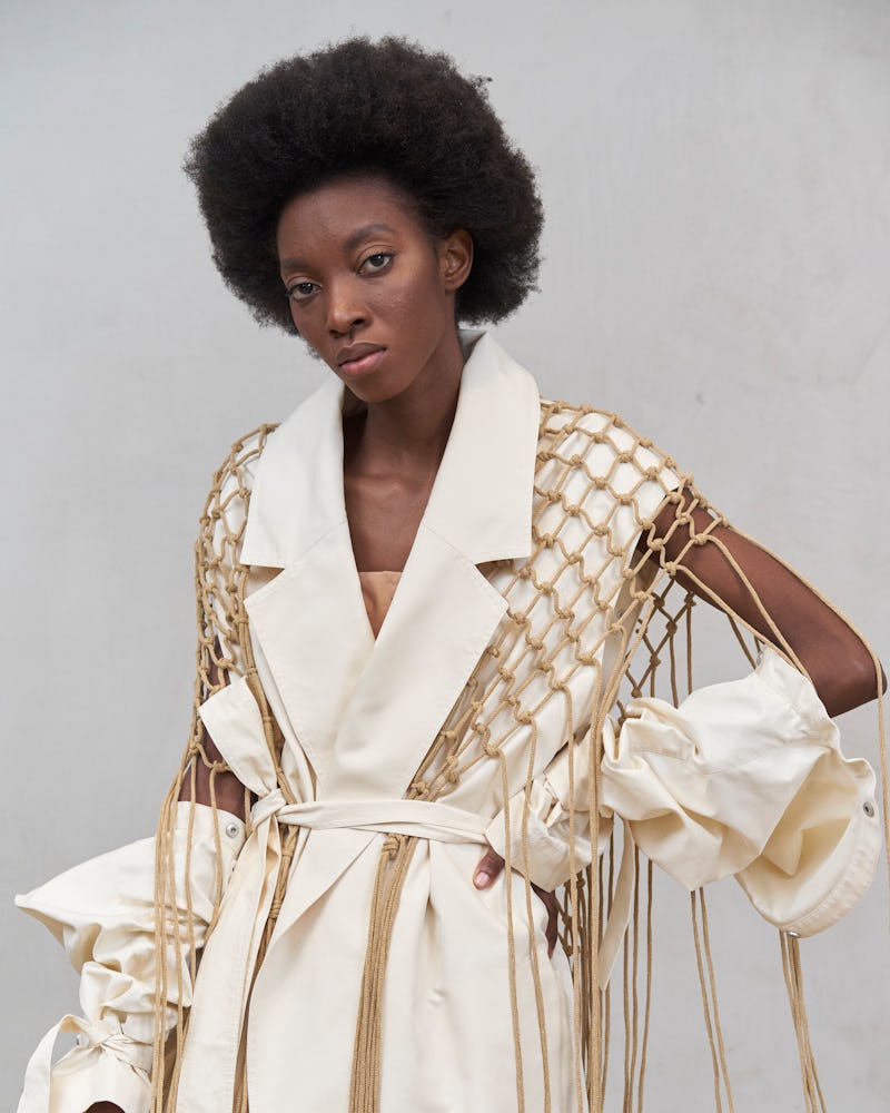 Model wearing a cut-out trench west from Ushatava Spring 2021 collection/campaign.