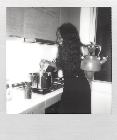 Actress Ego Nwodim, a cast member of SNL, wearing a black dress and holding a kettle in a black-and-...