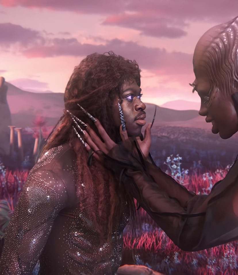 A screenshot from the “Montero (Call Me By Your Name)” music video, with Lil Nas X being embraced by...