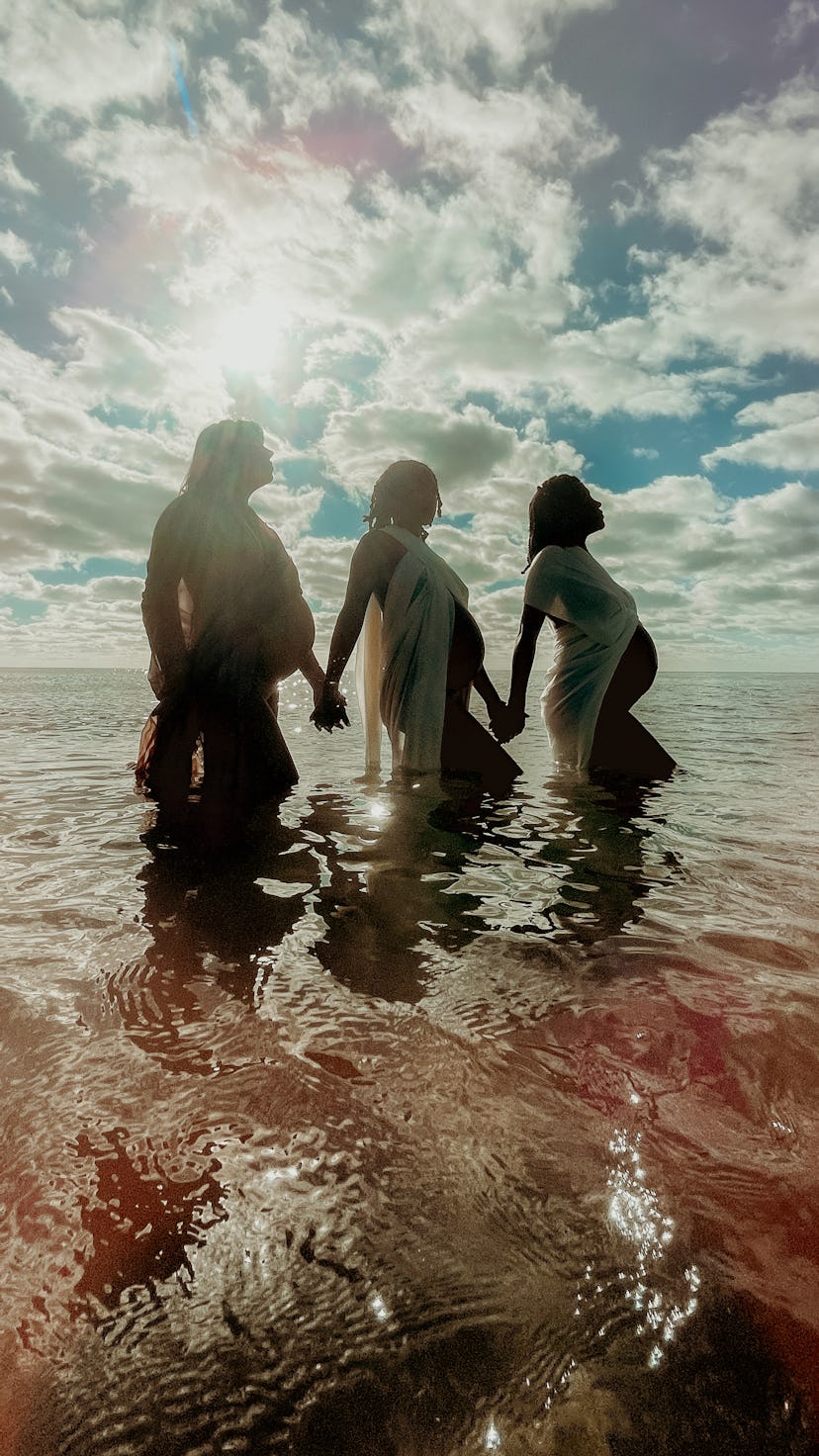 Three pregnant women in the water. Apple partnered with female photographers for an International Wo...