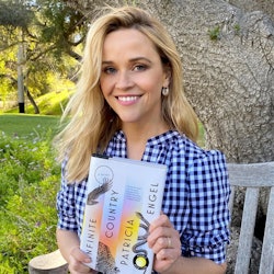 Reese Witherspoon holding a book.