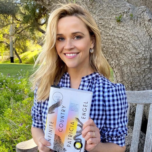 Reese Witherspoon holding a book.