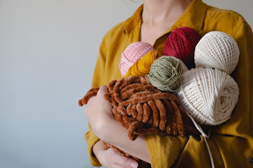 A woman holds skeins of yarn, a common early pandemic anxiety coping mechanism that may no longer be...
