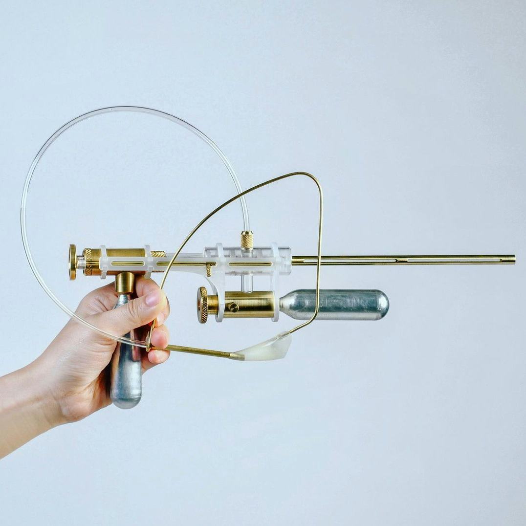 A brass gun that shoots tears is shown.