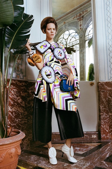 A model in a multicolored blouse and wide leather pants by Loewe