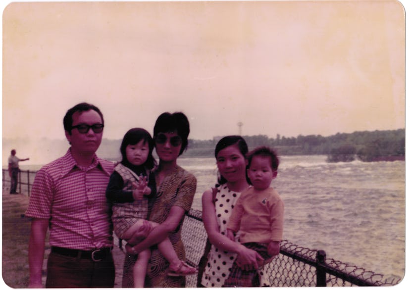 Taiwanese family posing on a shore in 70s, one man, two women and two smaller children, a boy and a ...