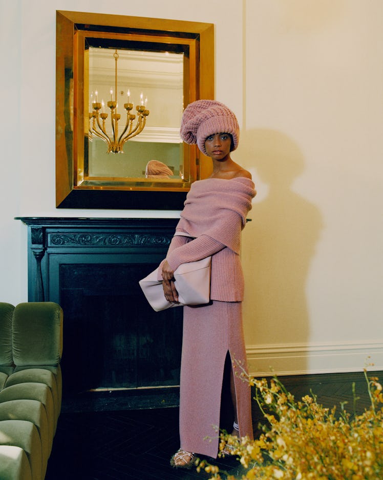 A model in a light pink knit dress and matching hat by Altuzarra