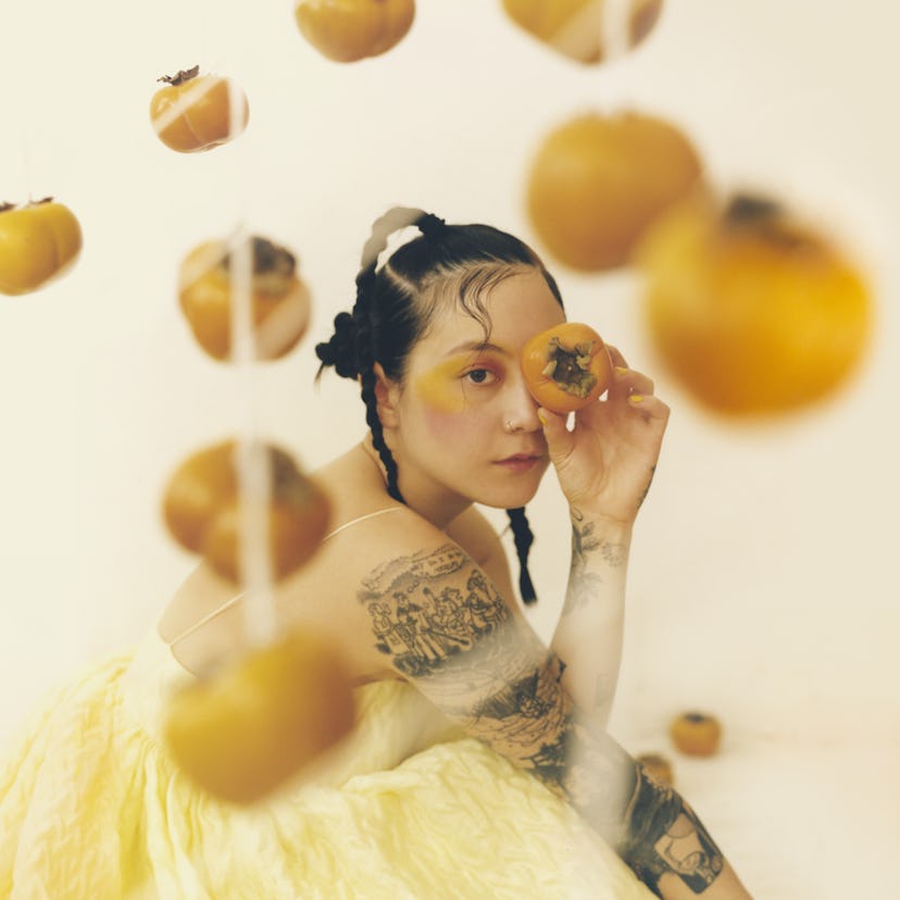 The cover of Japanese Breakfast's new album 'Jubilee.' She is wearing a pale yellow dress, holding a...