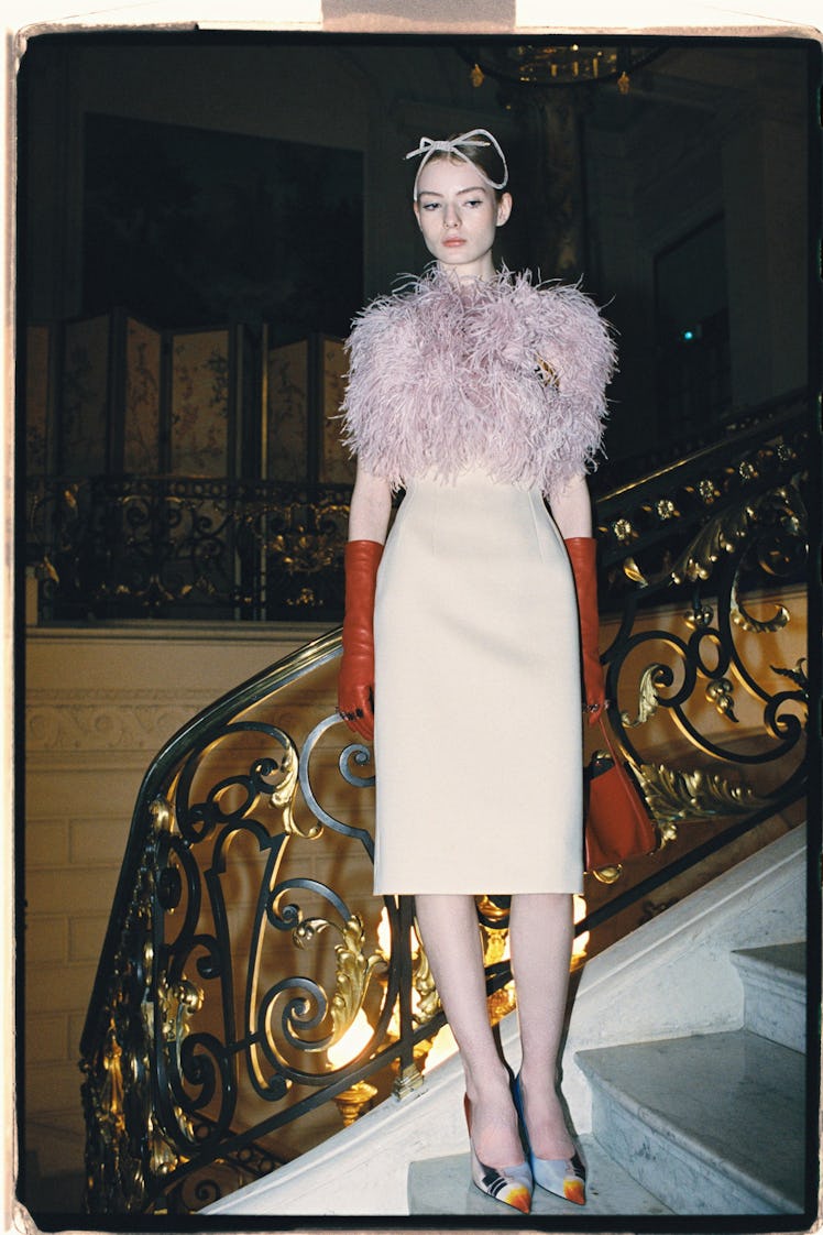 A model in a white feathered gown by Lanvin 