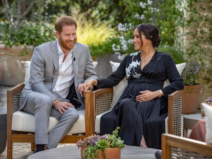 Prince Harry and Meghan Markle hold hands and laugh during their interview with Oprah Winfrey.