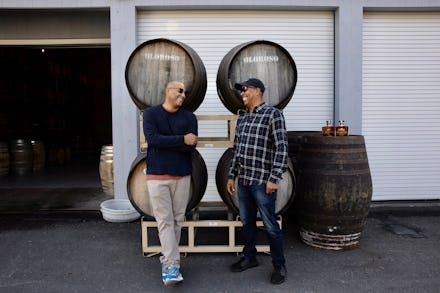 Two whiskey lovers standing in front of a whiskey distillery 
