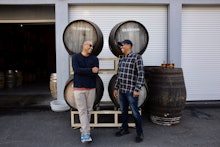 Two whiskey lovers standing in front of a whiskey distillery 