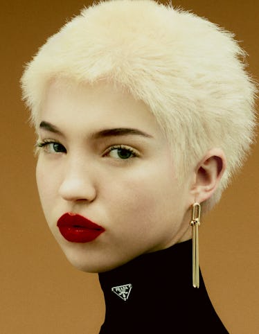 Lila Moss wears a Prada turtleneck; Tiffany & Co. earrings. Rouge Dior Satin Lipstick in #869 Sophis...