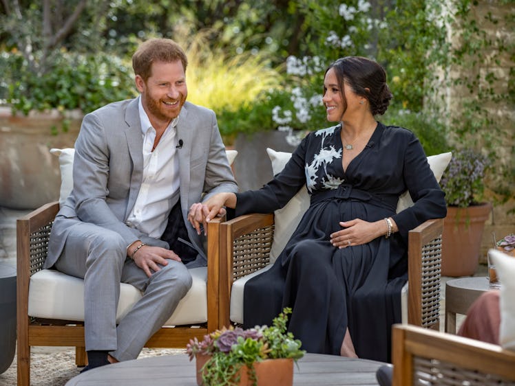 Prince Harry and Meghan Markle hold hands during their interview with Oprah Winfrey.