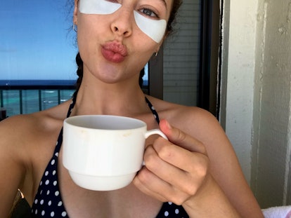 Alycia Debnam-Carey holding a cup of tea and wearing under-eye patches she swears by.