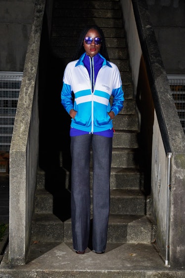 A model in a blue and white sports jacket with grey pants by Xuly.Bët