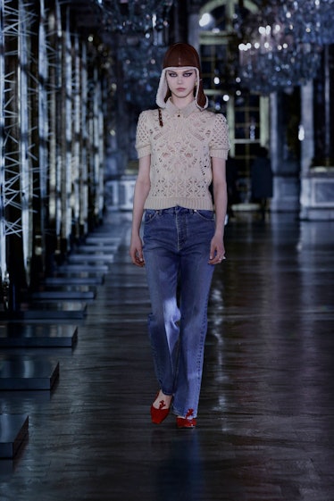A model in a white crochet blouse and jeans by Dior 